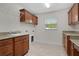 Well-equipped laundry room with cabinetry, countertop space, and a utility sink at 2954 Heiny Pl, The Villages, FL 32163