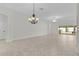 Expansive open-concept space with tile flooring and modern lighting at 2954 Heiny Pl, The Villages, FL 32163