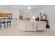 Bright living room open to the kitchen featuring tile floors, a large sectional, and a breakfast bar at 2954 Heiny Pl, The Villages, FL 32163