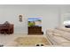 Cozy living room featuring a piano, entertainment center, and comfortable seating, creating a relaxing atmosphere at 2954 Heiny Pl, The Villages, FL 32163