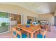 Covered patio with dining and seating areas perfect for outdoor entertaining at 2954 Heiny Pl, The Villages, FL 32163