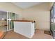Inviting covered patio featuring a stylish bar area, seamless access to indoor living spaces, and tile floors at 2954 Heiny Pl, The Villages, FL 32163