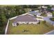 Lovely backyard featuring mature trees and lawn, enclosed by a white fence, providing privacy at 2954 Heiny Pl, The Villages, FL 32163