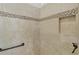 Shower featuring neutral tile with decorative band and built-in niche at 2954 Heiny Pl, The Villages, FL 32163