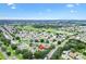 Panoramic aerial view showcasing the community's layout, golf course, and pond at 2991 Saint Thomas Ln, The Villages, FL 32162