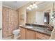 Bathroom boasts granite countertop, vanity lighting, and shower-tub combo at 2991 Saint Thomas Ln, The Villages, FL 32162