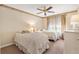 Bright bedroom with two twin beds, a ceiling fan, and neutral-toned decor at 2991 Saint Thomas Ln, The Villages, FL 32162