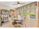 Bright breakfast nook features a glass table, decorative valances, and lots of natural light at 2991 Saint Thomas Ln, The Villages, FL 32162