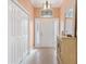 Inviting entryway with tile flooring, a decorative mirror, and ample closet space at 2991 Saint Thomas Ln, The Villages, FL 32162