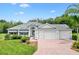 Charming single-story home featuring well-manicured landscaping and a three-car garage at 2991 Saint Thomas Ln, The Villages, FL 32162