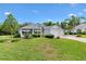 Charming single-story home featuring well-manicured landscaping and a three-car garage at 2991 Saint Thomas Ln, The Villages, FL 32162