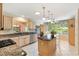 Spacious kitchen features granite countertops, stainless steel appliances, an island and a breakfast nook at 2991 Saint Thomas Ln, The Villages, FL 32162