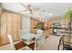 Eat-in kitchen features a glass table, stainless steel appliances, granite countertops, and neutral-toned cabinets at 2991 Saint Thomas Ln, The Villages, FL 32162