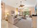 Spacious living room with high ceilings, large windows, and comfortable seating at 2991 Saint Thomas Ln, The Villages, FL 32162