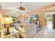 Inviting living room featuring large windows, comfortable seating, and an open floor plan at 2991 Saint Thomas Ln, The Villages, FL 32162