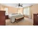 Relaxing main bedroom featuring a ceiling fan, neutral walls, and large windows at 2991 Saint Thomas Ln, The Villages, FL 32162