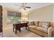 Comfortable office space with a wooden desk, couch, and natural light at 2991 Saint Thomas Ln, The Villages, FL 32162