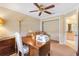 Bright office space with wooden desk, built in shelving, and neutral decor at 2991 Saint Thomas Ln, The Villages, FL 32162
