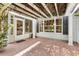 Charming covered patio with tile flooring and climbing vines, offering a relaxing outdoor space at 2991 Saint Thomas Ln, The Villages, FL 32162