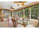 Enclosed sunroom features tile flooring, ceiling fans, and a view of greenery at 2991 Saint Thomas Ln, The Villages, FL 32162