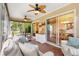 Inviting sunroom with tiled floor, ceiling fans, and lots of natural light at 2991 Saint Thomas Ln, The Villages, FL 32162