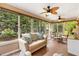 Cozy sunroom filled with natural light from numerous windows, including seating and dining area at 2991 Saint Thomas Ln, The Villages, FL 32162