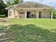 Large backyard featuring a covered patio, ceiling fans, and a picnic table at 30604 Apawamis Dr, Sorrento, FL 32776
