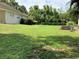 Sprawling backyard with mature trees, lush green grass, and a view of the house at 30604 Apawamis Dr, Sorrento, FL 32776