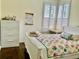 Cozy bedroom showcasing bright natural light, plantation shutters, and wood flooring at 30604 Apawamis Dr, Sorrento, FL 32776