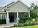 Inviting front porch with stately columns and manicured shrubbery at 30604 Apawamis Dr, Sorrento, FL 32776