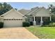 Charming single-story home with a two-car garage, well-maintained lawn, and inviting front porch at 30604 Apawamis Dr, Sorrento, FL 32776