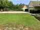 Spacious front yard with a long driveway, luscious grass, and a view of the house at 30604 Apawamis Dr, Sorrento, FL 32776