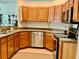 Bright kitchen featuring wood cabinets, stainless steel appliances, and neutral countertops at 30604 Apawamis Dr, Sorrento, FL 32776