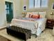 Comfortable main bedroom with a queen-size bed, a bench, and an ensuite bathroom at 30604 Apawamis Dr, Sorrento, FL 32776
