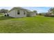 Expansive backyard with lush green grass and home exterior at 316 Dupont Cir, Howey In The Hills, FL 34737