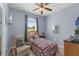 Cozy bedroom with lots of natural light and a comfortable chair at 316 Dupont Cir, Howey In The Hills, FL 34737