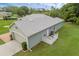 Aerial view of home showcasing attached garage and well-maintained lawn at 316 Dupont Cir, Howey In The Hills, FL 34737
