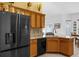 Beautiful kitchen features stainless steel refrigerator, tiled floors, and wood cabinets at 316 Dupont Cir, Howey In The Hills, FL 34737