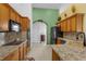 Spacious kitchen features granite countertops, oak cabinetry and a built-in microwave and oven at 316 Dupont Cir, Howey In The Hills, FL 34737