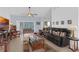 Bright living room with ceiling fan, tiled floors, and view to outside at 316 Dupont Cir, Howey In The Hills, FL 34737