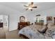 Inviting main bedroom with a ceiling fan, dresser, and access to the living room at 316 Dupont Cir, Howey In The Hills, FL 34737