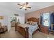 This bedroom features a wooden bed frame, tiled floor, and view to the living room at 316 Dupont Cir, Howey In The Hills, FL 34737