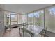Bright sunroom with tiled flooring and a glass-topped table and chairs set at 316 Dupont Cir, Howey In The Hills, FL 34737