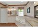 Bright bathroom with a jacuzzi tub, double sinks with granite counters, and floral wallpaper trim at 32948 Rambling Oaks Ct, Leesburg, FL 34748