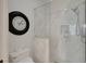 Modern bathroom featuring tiled shower with glass door, toilet, and decorative clock at 32948 Rambling Oaks Ct, Leesburg, FL 34748