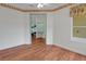 Bright bedroom with wood floors, a large window, and seamless access to other rooms at 32948 Rambling Oaks Ct, Leesburg, FL 34748