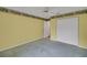Bedroom featuring a large closet with white doors, ceiling fan, and carpet at 32948 Rambling Oaks Ct, Leesburg, FL 34748