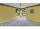 Bright bedroom with ceiling fan, carpet, and view of the front yard at 32948 Rambling Oaks Ct, Leesburg, FL 34748
