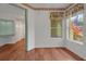 Cozy bedroom with wood floors, a large window, and easy access to other rooms at 32948 Rambling Oaks Ct, Leesburg, FL 34748