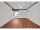 Bedroom featuring hardwood floors, floral wallpaper trim, and a ceiling fan at 32948 Rambling Oaks Ct, Leesburg, FL 34748